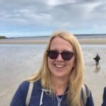 Elaine at the beach, wearing sunglasses